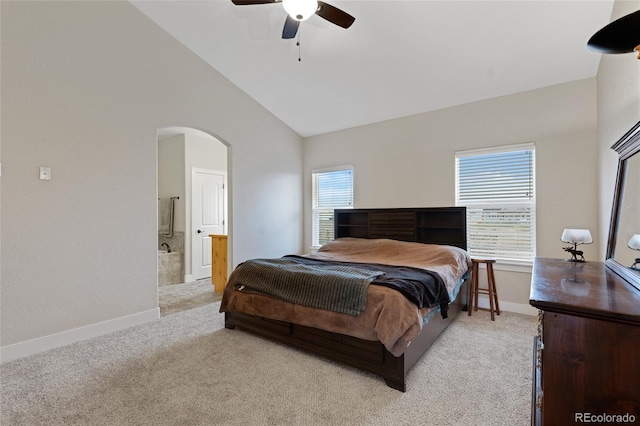 bedroom with light carpet, connected bathroom, high vaulted ceiling, and ceiling fan