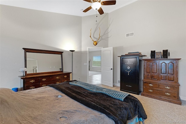 bedroom with ceiling fan and light colored carpet