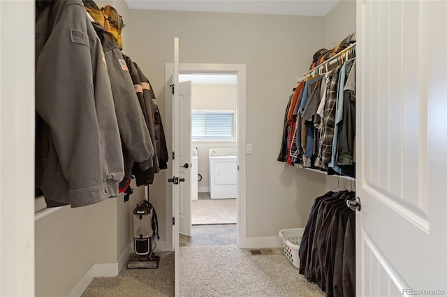 walk in closet featuring light colored carpet and washer / clothes dryer