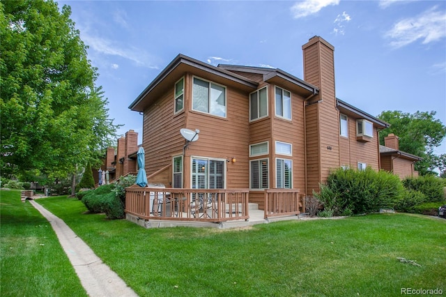 5555 E Briarwood Ave Unit 603, Centennial, CO 80122 - back of house featuring a chimney, a lawn, and a wooden deck