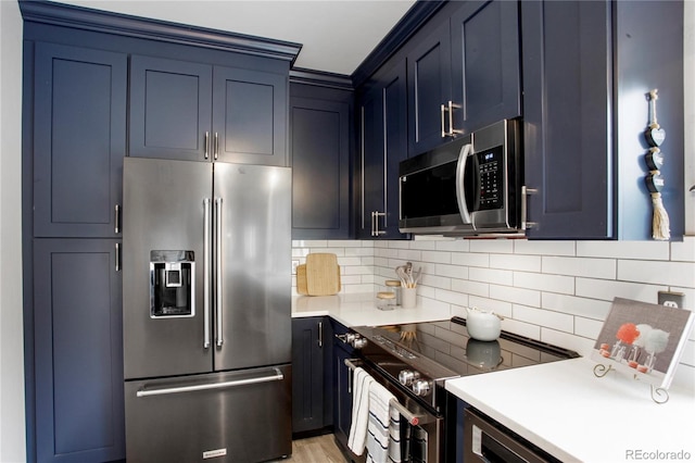 5555 E Briarwood Ave Unit 603, Centennial, CO 80122 - kitchen featuring stainless steel appliances, decorative backsplash, light countertops, and blue cabinetry