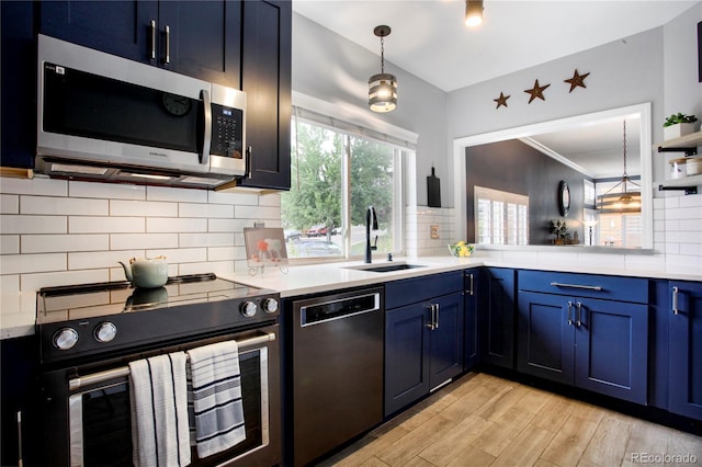 5555 E Briarwood Ave Unit 603, Centennial, CO 80122 - kitchen featuring stainless steel appliances, blue cabinetry, light countertops, and light wood finished floors