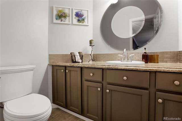 5555 E Briarwood Ave Unit 603, Centennial, CO 80122 - bathroom featuring vanity, backsplash, and wood finished floors