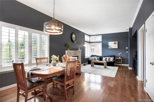 5555 E Briarwood Ave Unit 603, Centennial, CO 80122 - dining space featuring plenty of natural light, wood finished floors, a chandelier, a fireplace, and crown molding
