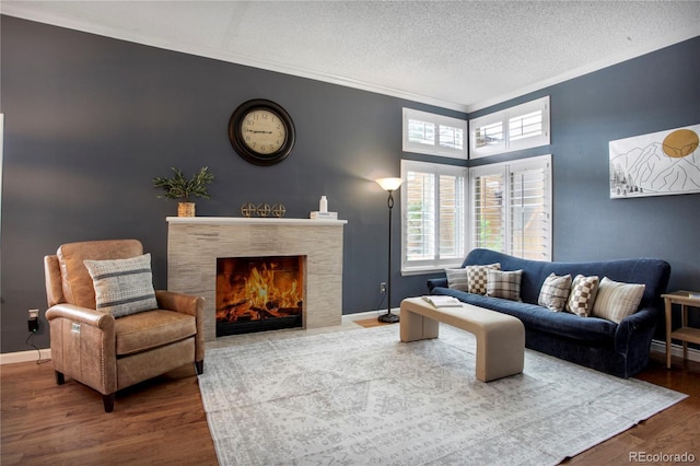 5555 E Briarwood Ave Unit 603, Centennial, CO 80122 - living room with wood finished floors, ornamental molding, a tile fireplace, and a textured ceiling