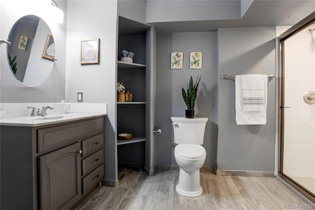 5555 E Briarwood Ave Unit 603, Centennial, CO 80122 - full bathroom featuring vanity, wood finished floors, a shower stall, and built in features
