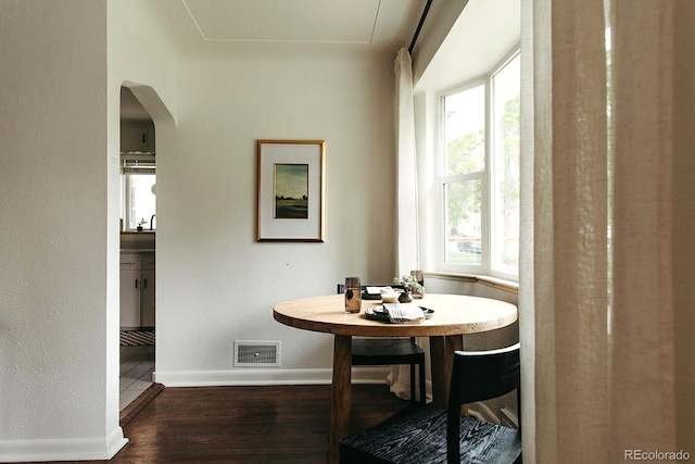 4422 W 27th Ave, Denver, CO 80212 - dining space with wood finished floors, baseboards, and arched walkways