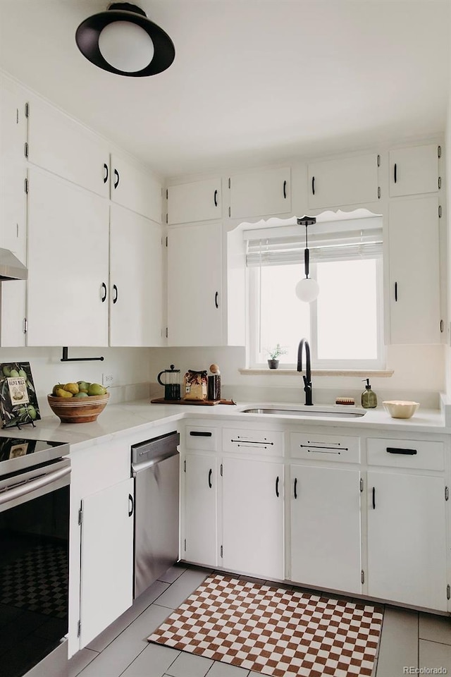 4422 W 27th Ave, Denver, CO 80212 - kitchen featuring appliances with stainless steel finishes, a sink, light countertops, white cabinetry, and under cabinet range hood