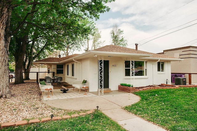 4422 W 27th Ave, Denver, CO 80212 - view of front of house with central AC, a patio, brick siding, and roof with shingles