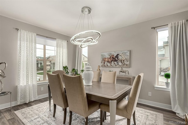 5964 E 141st Ave, Thornton, CO 80602 - dining space with a chandelier, wood finished floors, and baseboards