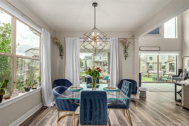 5964 E 141st Ave, Thornton, CO 80602 - dining space with a chandelier, wood finished floors, and baseboards
