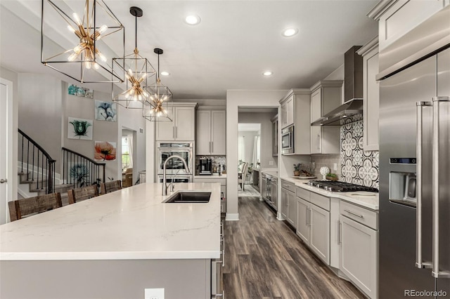 5964 E 141st Ave, Thornton, CO 80602 - kitchen featuring built in appliances, a sink, wall chimney range hood, gray cabinets, and recessed lighting
