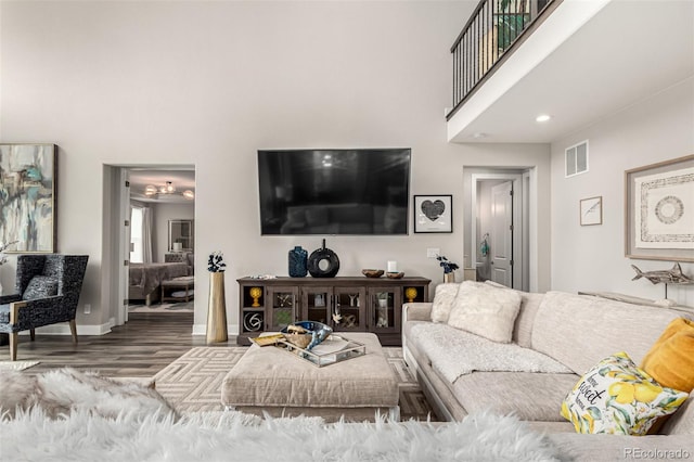 5964 E 141st Ave, Thornton, CO 80602 - living room featuring wood finished floors, a towering ceiling, and recessed lighting