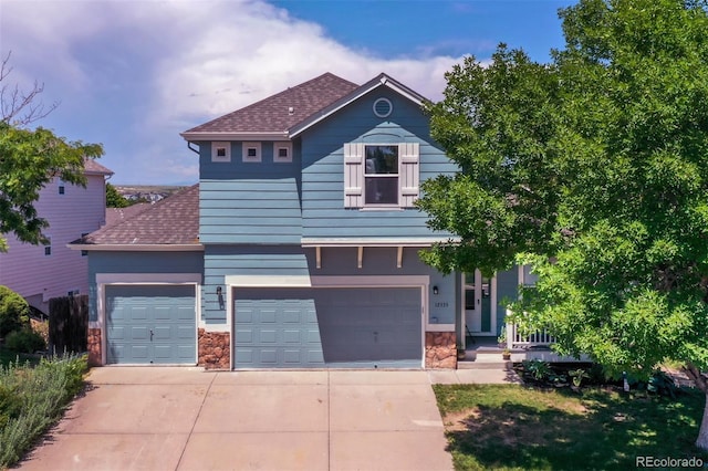 12535 S Beaver Creek Way, Parker, CO 80134 - view of front of property featuring roof with shingles, stone siding, and concrete driveway