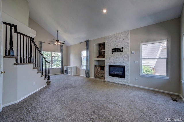 12535 S Beaver Creek Way, Parker, CO 80134 - unfurnished living room featuring built in features, carpet, a ceiling fan, stairs, and high vaulted ceiling