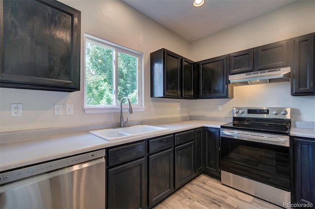 12535 S Beaver Creek Way, Parker, CO 80134 - kitchen featuring appliances with stainless steel finishes, under cabinet range hood, light wood finished floors, light countertops, and recessed lighting