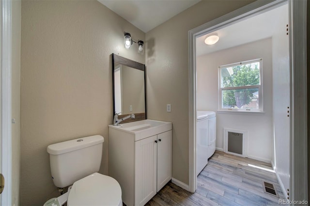 12535 S Beaver Creek Way, Parker, CO 80134 - bathroom featuring separate washer and dryer, wood finished floors, and vanity