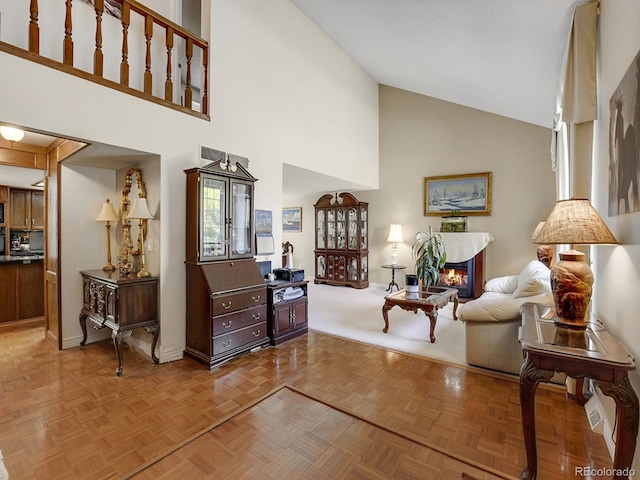 living room featuring parquet flooring and high vaulted ceiling