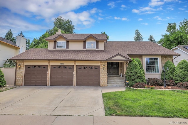 view of front facade with a garage and a front yard