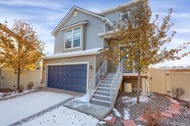 17938 E 54th Ave, Denver, CO 80249 - view of front of property featuring driveway, fence, an attached garage, stairs, and a gate