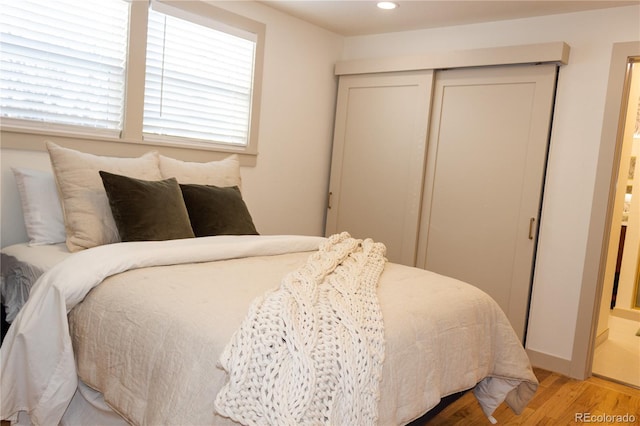 bedroom featuring light hardwood / wood-style floors and a closet