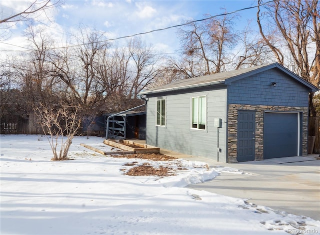 view of snow covered exterior with a garage