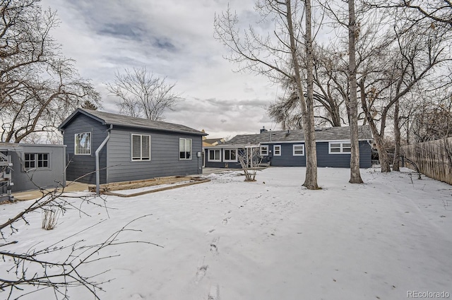 view of snow covered rear of property