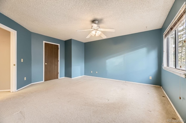 unfurnished bedroom featuring carpet flooring, ceiling fan, and a textured ceiling