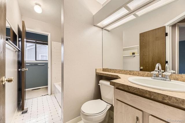 bathroom with tile patterned floors, vanity, and toilet