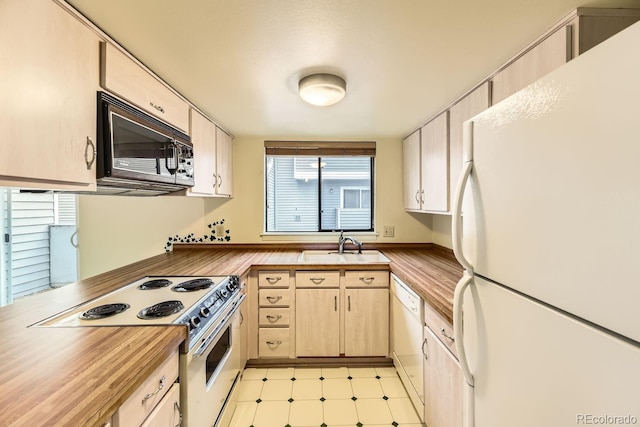 kitchen featuring wooden counters, white appliances, and sink