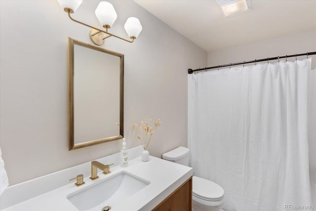 bathroom featuring vanity, a shower with shower curtain, and toilet