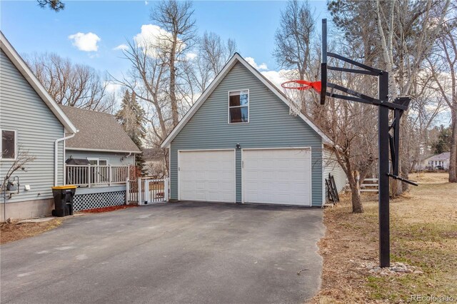 view of property exterior featuring an outdoor structure and a garage