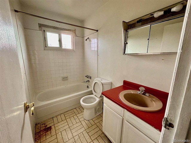 full bathroom featuring toilet, vanity, and tiled shower / bath