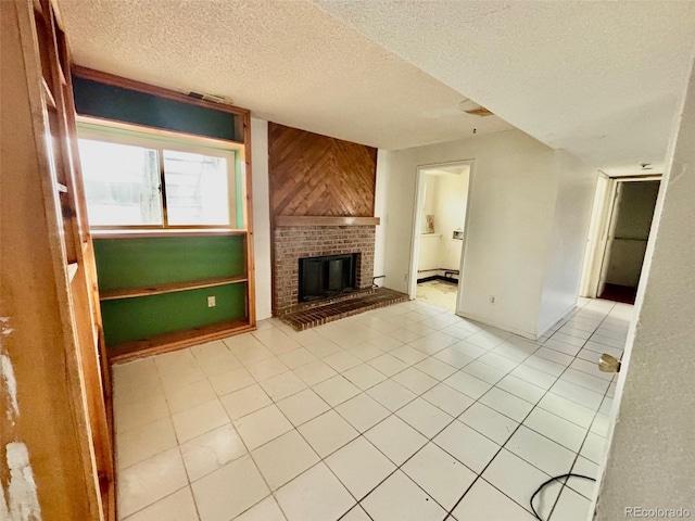 unfurnished living room featuring wood walls, a textured ceiling, and a brick fireplace