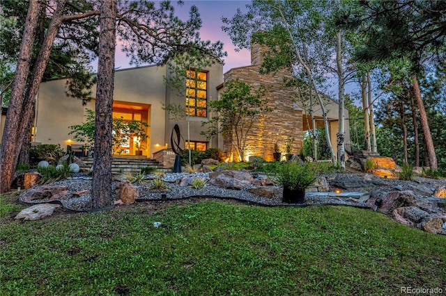 1250 Dolan Dr, Monument, CO 80132 - view of front facade featuring stucco siding and a front yard