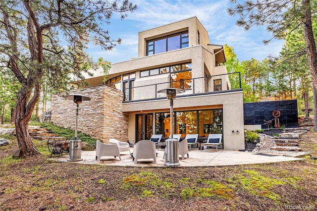 1250 Dolan Dr, Monument, CO 80132 - back of house with a balcony, a patio, and stucco siding