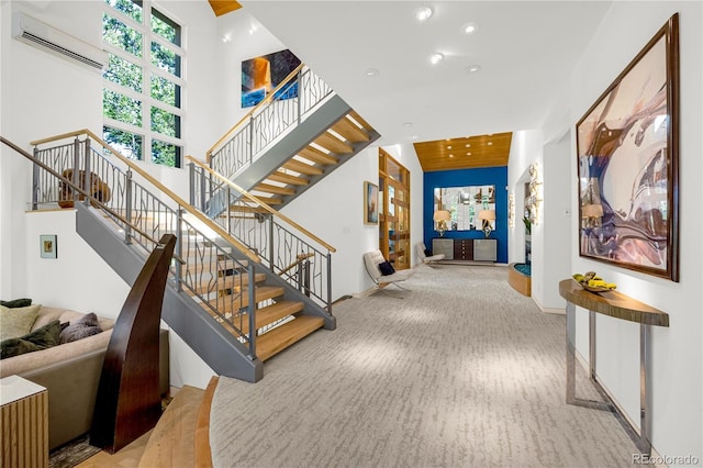 1250 Dolan Dr, Monument, CO 80132 - staircase featuring an AC wall unit, carpet floors, a towering ceiling, and recessed lighting