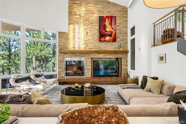 1250 Dolan Dr, Monument, CO 80132 - living area featuring high vaulted ceiling, a large fireplace, and a wall mounted air conditioner