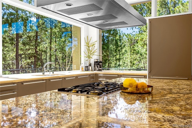 1250 Dolan Dr, Monument, CO 80132 - kitchen with stainless steel gas cooktop, exhaust hood, and stone counters