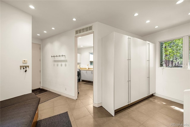 1250 Dolan Dr, Monument, CO 80132 - entrance foyer featuring recessed lighting, light tile patterned floors, and washer / dryer