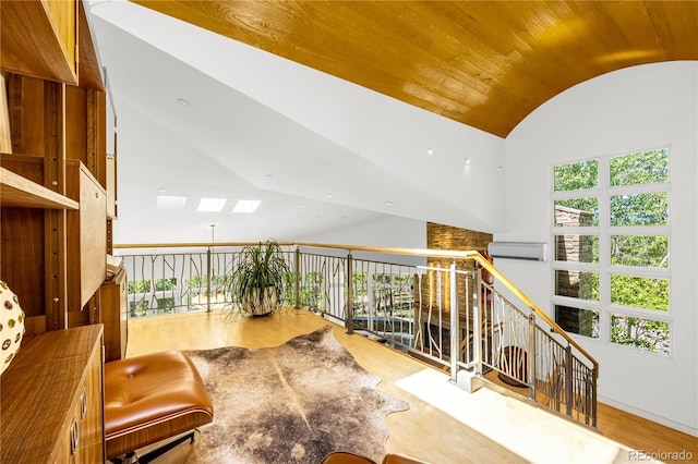 1250 Dolan Dr, Monument, CO 80132 - sitting room with vaulted ceiling, wood finished floors, a wall mounted air conditioner, and wood ceiling
