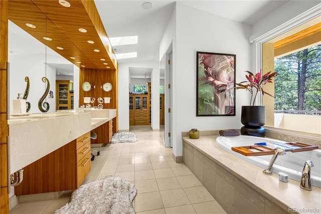 1250 Dolan Dr, Monument, CO 80132 - full bathroom featuring a skylight, vanity, tile patterned flooring, a bath, and recessed lighting