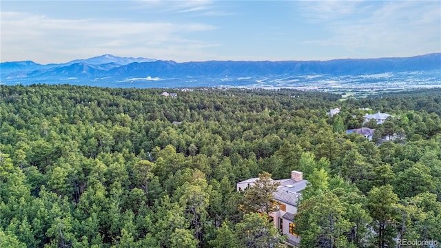 1250 Dolan Dr, Monument, CO 80132 - drone / aerial view of a heavily wooded area and a mountain backdrop