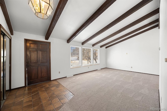 foyer featuring lofted ceiling with beams, dark colored carpet, and a chandelier