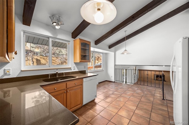 kitchen with dark countertops, hanging light fixtures, glass insert cabinets, a sink, and white appliances