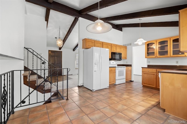 kitchen with white appliances, dark countertops, glass insert cabinets, and decorative light fixtures