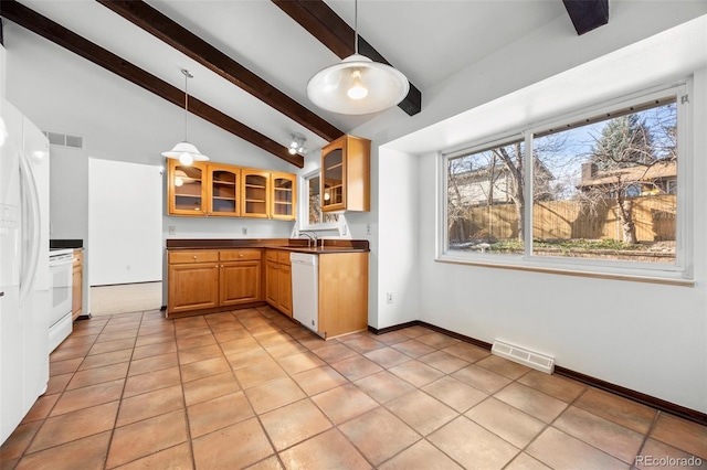 kitchen featuring dark countertops, white appliances, glass insert cabinets, and pendant lighting