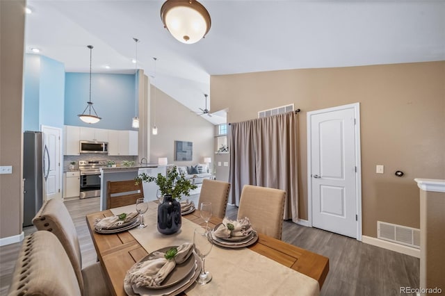 8626 Gold Peak Dr Unit B, Highlands Ranch, CO 80130 - dining space with high vaulted ceiling, light wood finished floors, and a ceiling fan