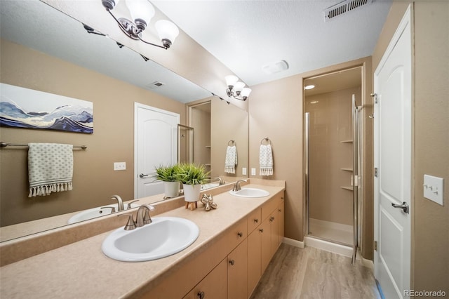 8626 Gold Peak Dr Unit B, Highlands Ranch, CO 80130 - bathroom featuring double vanity, wood finished floors, and a stall shower