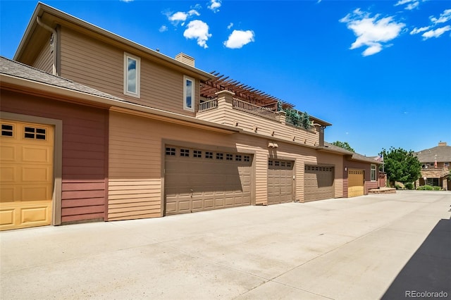 8626 Gold Peak Dr Unit B, Highlands Ranch, CO 80130 - view of front of house featuring a balcony, a chimney, and an attached garage